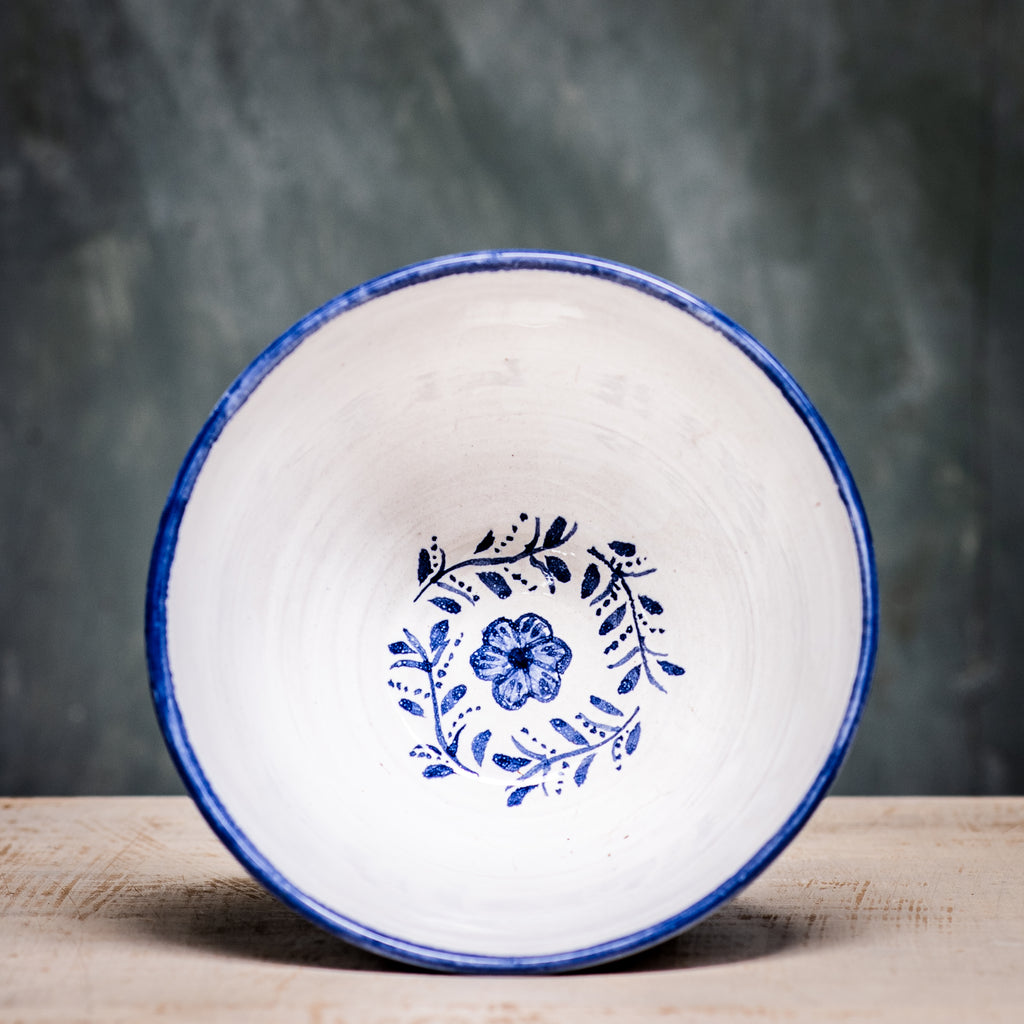 A ceramic pudding bowl with a floral pattern in blue and white colors on a white background.