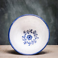 A ceramic pudding bowl with a floral pattern in blue and white colors on a white background.