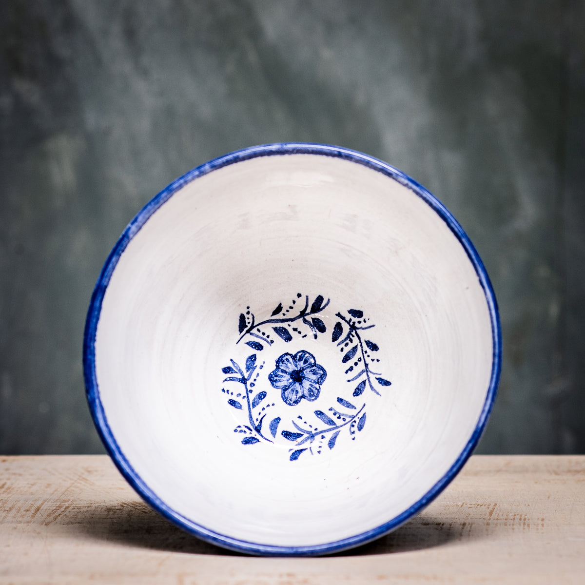 A ceramic pudding bowl with a floral pattern in blue and white colors on a white background.