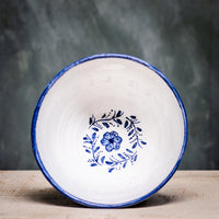 A ceramic pudding bowl with a floral pattern in blue and white colors on a white background.